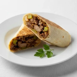 Vegan Sawda wrap with aubergine, potato, tomato, pepper, onion, tahini, and pickles.