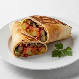 Musakkaa wrap with grilled chicken liver, caramelised onion, garlic sauce, and pickles.