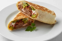 Sujuk lamb wrap with garlic sauce, fenugreek, spices, and pickles – authentic Middle Eastern street food at Utopia Mercato London